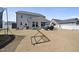 Grassy backyard offering ample play space, featuring a trampoline, playset and grilling area at 239 Hopper Cir, Clayton, NC 27520