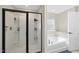 Stylish bathroom with glass-enclosed shower and a separate soaking tub, creating a spa-like experience at 239 Hopper Cir, Clayton, NC 27520