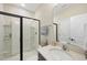Modern bathroom featuring a walk-in shower, vanity with sink, and tiled walls at 239 Hopper Cir, Clayton, NC 27520