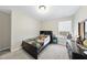 Cozy bedroom with a dark wood bed frame, bedside table, and carpeted floors at 239 Hopper Cir, Clayton, NC 27520