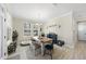 Bright dining room with wooden table, bench, and complementary decor, illuminated by a charming chandelier and natural light at 239 Hopper Cir, Clayton, NC 27520