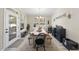 Bright dining room with wooden table, bench, and complementary decor, illuminated by a charming chandelier and natural light at 239 Hopper Cir, Clayton, NC 27520