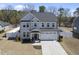 Charming two-story home with a well-manicured lawn, a two-car garage, and a welcoming front porch at 239 Hopper Cir, Clayton, NC 27520