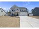 Attractive two-story home with a two-car garage, a concrete driveway, and a landscaped front yard at 239 Hopper Cir, Clayton, NC 27520