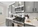 Close-up of the kitchen highlighting stainless steel appliances, quartz countertops, and stylish cabinetry at 239 Hopper Cir, Clayton, NC 27520