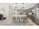 Stylish kitchen features gray cabinets, stainless steel appliances, and a central island with barstool seating at 239 Hopper Cir, Clayton, NC 27520