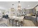 Open-concept kitchen boasts a center island with seating and modern pendant lighting at 239 Hopper Cir, Clayton, NC 27520