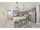 Well-equipped kitchen with a large island, modern lighting, and gray cabinetry at 239 Hopper Cir, Clayton, NC 27520