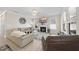 Comfortable living room featuring a cozy fireplace, a large television, and plush seating, perfect for relaxation at 239 Hopper Cir, Clayton, NC 27520