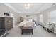 Spacious main bedroom with tray ceiling, sitting area, and serene decor, creating a relaxing retreat at 239 Hopper Cir, Clayton, NC 27520