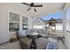 Screened porch featuring a cozy seating area with a ceiling fan and view of the backyard playset at 239 Hopper Cir, Clayton, NC 27520
