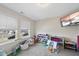 Bright ' room with large windows, TV, and ample toy storage on neutral carpet at 239 Hopper Cir, Clayton, NC 27520