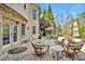 Beautifully landscaped backyard with a brick patio featuring comfortable seating and manicured lawn at 2550 Bittersweet Dr, Durham, NC 27705