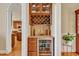 A bar area featuring a wine cooler and storage, as well as a view to the kitchen at 2550 Bittersweet Dr, Durham, NC 27705