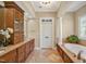 Elegant bathroom with a soaking tub, double vanity, and travertine tile floors at 2550 Bittersweet Dr, Durham, NC 27705