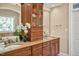 Bathroom featuring double sinks, decorative vanity, and an open mirror cabinet at 2550 Bittersweet Dr, Durham, NC 27705