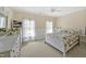 Spacious bedroom featuring two windows and a dresser and TV for a modern feel at 2550 Bittersweet Dr, Durham, NC 27705