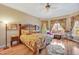 Comfortable bedroom featuring a king-size bed, hardwood floors, and large windows at 2550 Bittersweet Dr, Durham, NC 27705