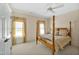 Comfortable bedroom featuring a four-poster bed, plush carpeting, and natural light at 2550 Bittersweet Dr, Durham, NC 27705
