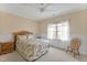 Comfortable bedroom with a ceiling fan, bright window, and coordinated furnishings at 2550 Bittersweet Dr, Durham, NC 27705