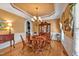 Traditional dining room with wood floors, chandelier, and built-in cabinet at 2550 Bittersweet Dr, Durham, NC 27705
