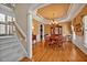 Dining room featuring a wood table, classic chandelier, and stairs at 2550 Bittersweet Dr, Durham, NC 27705