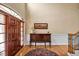 Bright foyer boasts a wood front door, high ceilings, wood floors, and a decorative table with art at 2550 Bittersweet Dr, Durham, NC 27705