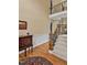 Inviting foyer featuring wood floors, a staircase, and decorative table with artwork at 2550 Bittersweet Dr, Durham, NC 27705