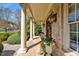 Inviting front porch featuring classic columns and well-manicured landscaping at 2550 Bittersweet Dr, Durham, NC 27705
