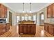 Bright kitchen with wooden cabinets and a granite countertop island and backsplash at 2550 Bittersweet Dr, Durham, NC 27705
