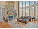 Bright living room with a stone fireplace and large windows offering ample natural light at 2550 Bittersweet Dr, Durham, NC 27705