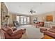 Spacious living room with a stone fireplace, French doors, and comfortable leather furniture at 2550 Bittersweet Dr, Durham, NC 27705