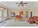 Spacious living room with a ceiling fan, access to the outside, and an open floor plan to the bar and kitchen at 2550 Bittersweet Dr, Durham, NC 27705