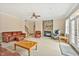 Inviting living room featuring a stone fireplace, ceiling fan, and an open floor plan at 2550 Bittersweet Dr, Durham, NC 27705