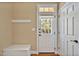 Functional mudroom featuring a bench, coat hooks, and a door to the outside at 2550 Bittersweet Dr, Durham, NC 27705