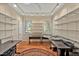 Well-lit home office with two windows, hardwood floors, and built-in shelving and multiple desks at 2550 Bittersweet Dr, Durham, NC 27705