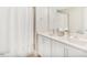 Modern bathroom featuring dual sinks, white cabinets, and a shower with white curtain at 262 Cardovia Way, Wendell, NC 27591