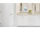 Bathroom featuring double sinks, granite countertops, and white cabinetry at 262 Cardovia Way, Wendell, NC 27591