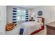 Cozy bedroom with baseball themed decor, a twin sized bed, and a window with blue and white striped curtains at 262 Cardovia Way, Wendell, NC 27591