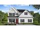 Charming two-story home featuring black shutters, a red front door, and classic architectural design at 262 Cardovia Way, Wendell, NC 27591