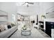 Bright living room featuring high ceilings, a fireplace, an open layout, and a modern neutral color palette at 262 Cardovia Way, Wendell, NC 27591