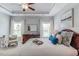 Comfortable main bedroom with tray ceiling, a ceiling fan, and neutral decor at 262 Cardovia Way, Wendell, NC 27591