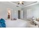 Serene main bedroom featuring neutral paint, tray ceiling, and access to the ensuite bathroom at 262 Cardovia Way, Wendell, NC 27591