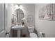 Stylish powder room with a pedestal sink, decorative mirror, and modern fixtures at 262 Cardovia Way, Wendell, NC 27591