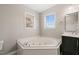Corner bathtub in a bathroom with a double window for natural light at 2621 Wellington Ridge Loop, Cary, NC 27518