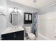 Well-lit bathroom featuring a modern vanity, a mirrored medicine cabinet, and a shower with a patterned curtain at 2621 Wellington Ridge Loop, Cary, NC 27518
