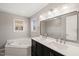 Bathroom features a double vanity, bathtub and a wall mirror at 2621 Wellington Ridge Loop, Cary, NC 27518