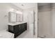 Bathroom with a double sink vanity, large mirror and glass enclosed shower at 2621 Wellington Ridge Loop, Cary, NC 27518