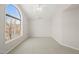 Empty bedroom featuring a large window for natural light and a ceiling fan at 2621 Wellington Ridge Loop, Cary, NC 27518