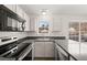Bright kitchen featuring stainless steel appliances, gray countertops and a window over the sink at 2621 Wellington Ridge Loop, Cary, NC 27518